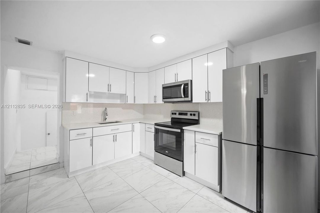A closer look at the kitchen's stainless steel appliances and practical cabinet layout.