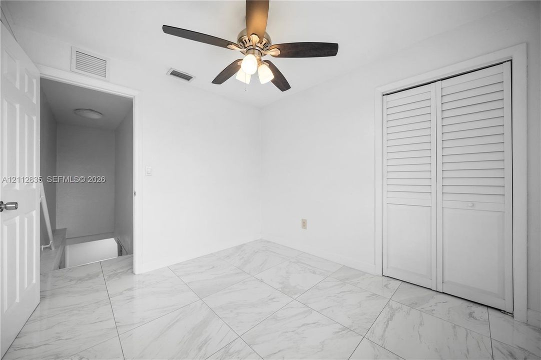 Another bedroom perspective highlighting the layout and closet access.