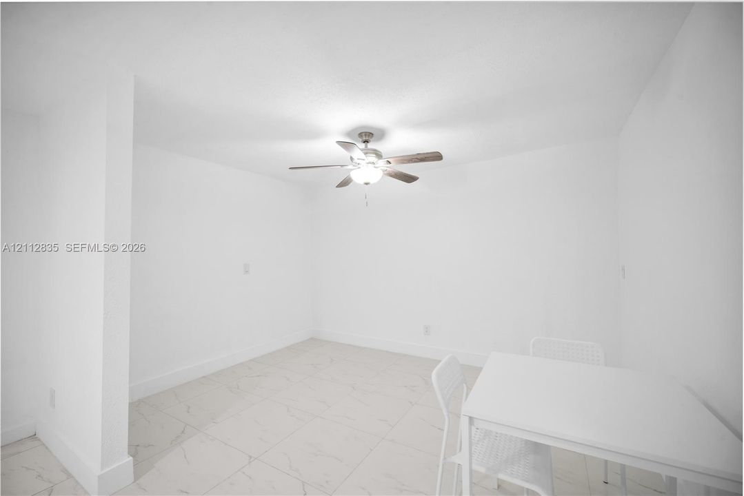 Living and dining area featuring ceramic tile flooring and ceiling fan. ready for your personal touch.