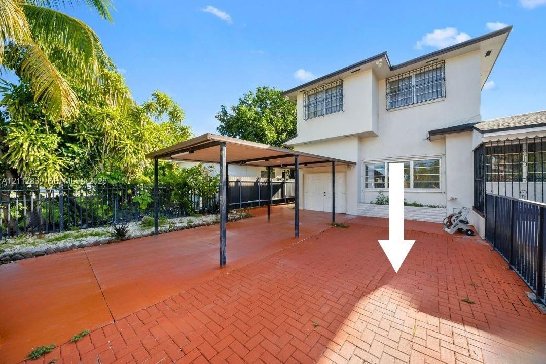 A look at the fully fenced property and its paved outdoor area. Assigned parking spaces