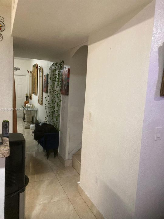 Large-format tile flooring and architectural arched entryway