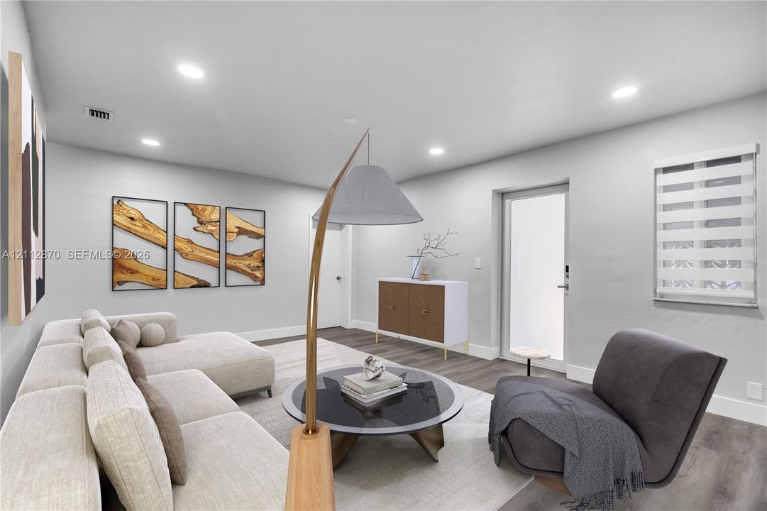 Living area featuring wood-finish flooring, recessed lighting, and a neutral color palette