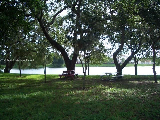 Expansive grounds featuring mature shade trees and direct frontage on a private lake