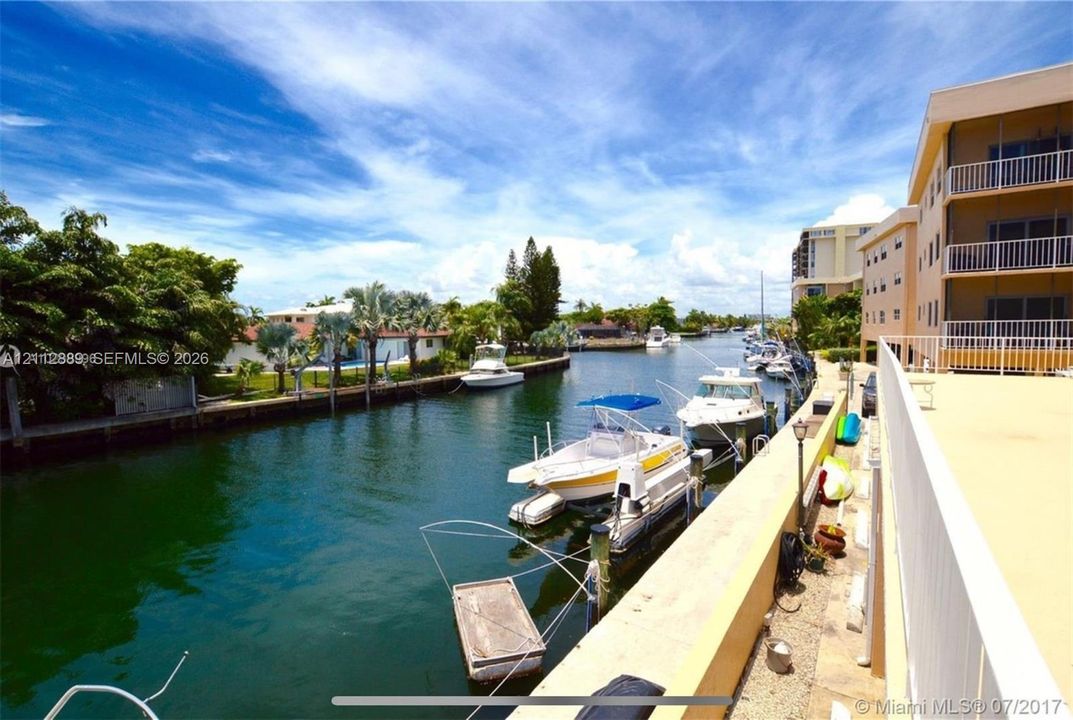 Waterfront property featuring a concrete seawall, deep-water canal access, and dedicated boat docking