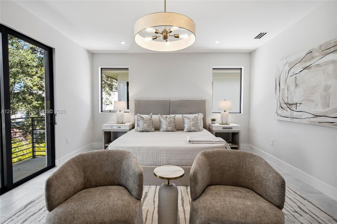 Bedroom featuring large-format tile flooring, a multi-bulb drum pendant light fixture, and black-framed sliding glass doors opening to a balcony