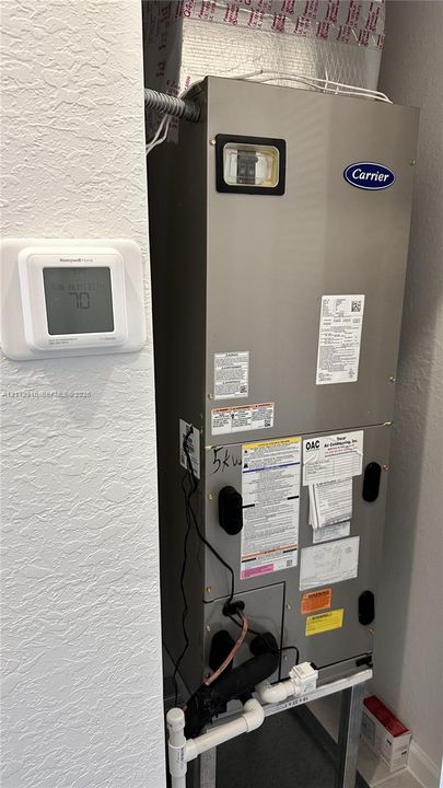 Carrier HVAC air handler unit featuring a digital Honeywell thermostat