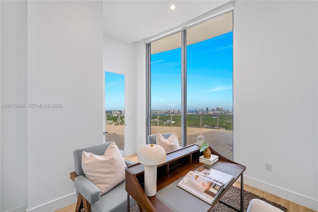 Floor-to-ceiling windows, wood-finish flooring, recessed lighting, and access to an exterior terrace
