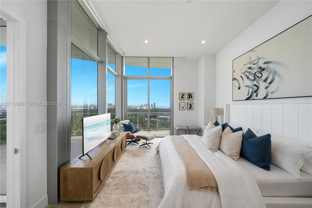 Floor-to-ceiling glass walls, sliding glass door, recessed lighting, and expansive private balcony with outdoor railing