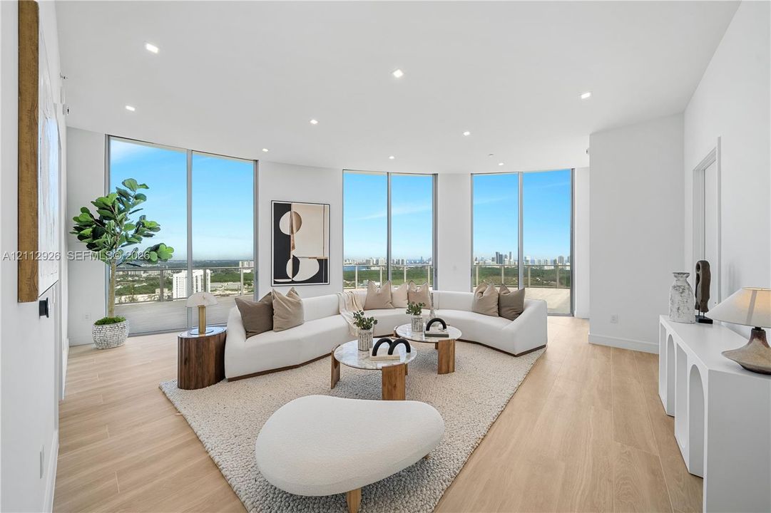 Open-concept interior featuring floor-to-ceiling glass windows, wood-finish flooring, and recessed ceiling lighting