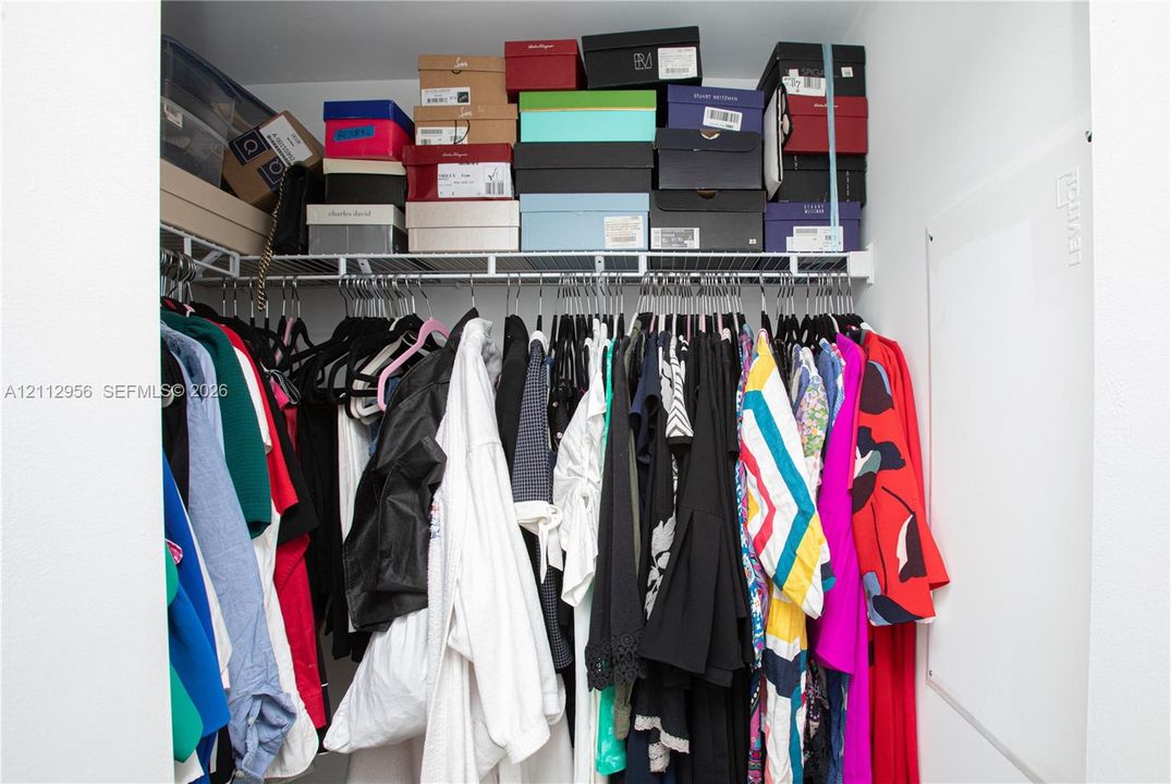 White-finished closet featuring built-in wire shelving and a wall-mounted electrical panel
