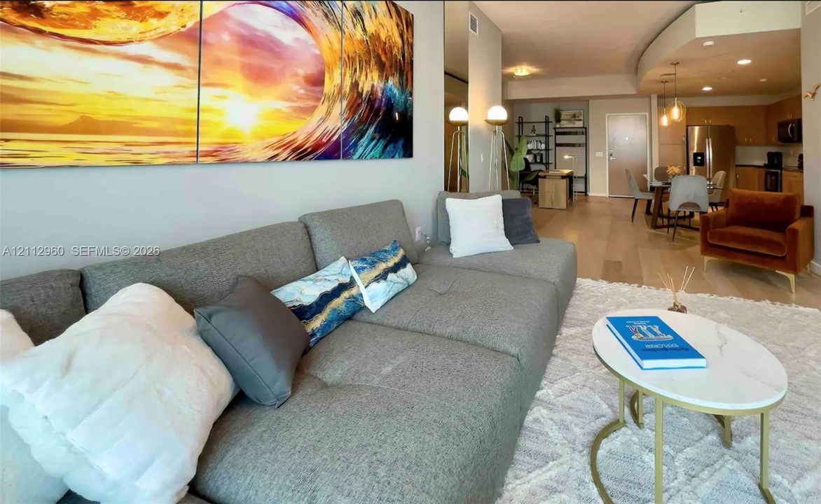 Wood-finish flooring, recessed lighting, and kitchen cabinetry with stainless steel appliances