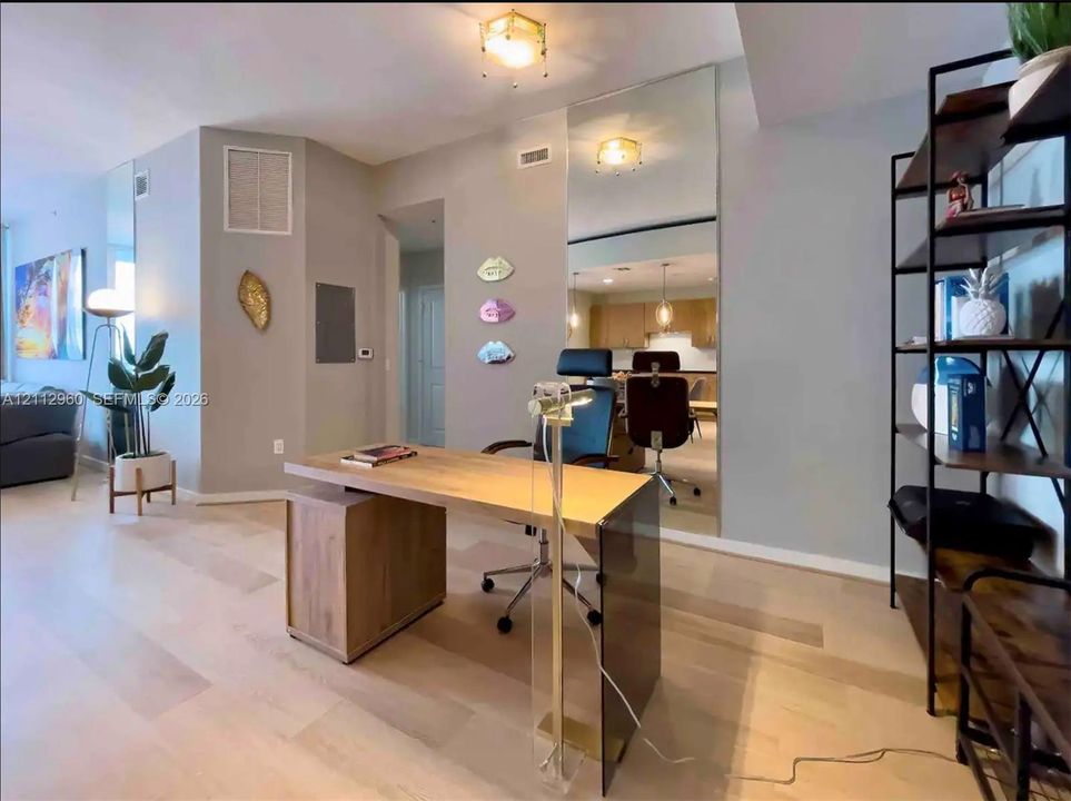 Wide-plank wood-finish flooring, floor-to-ceiling wall mirror, and flush-mount interior lighting