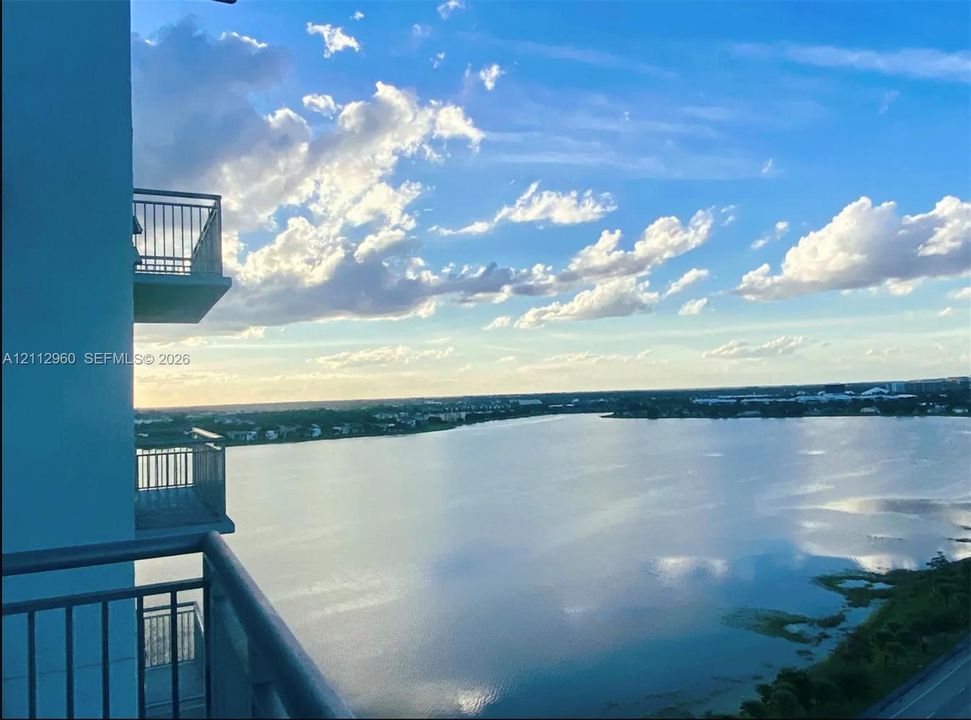 Stacked private balconies featuring metal railings with expansive water frontage and horizon scenery