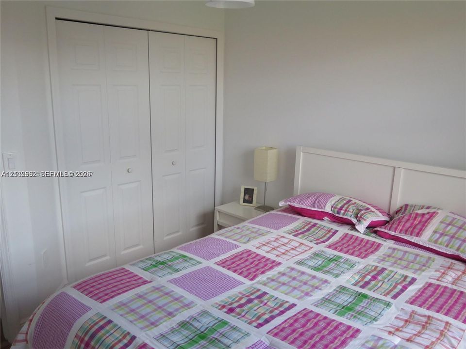 Bi-fold closet doors with white finish and neutral wall paint