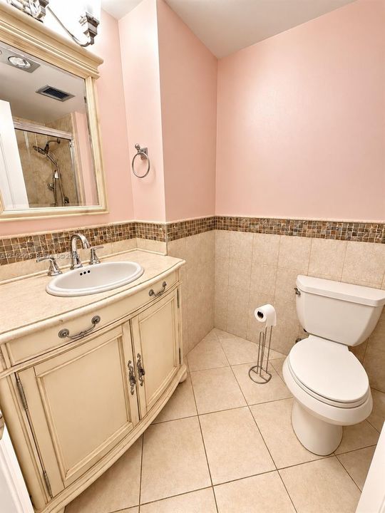 Vanity featuring an integrated oval sink, stone-finish countertop, and decorative cabinet hardware