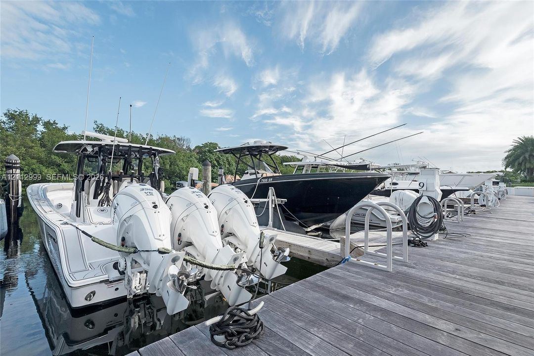 Deep-water boat slips featuring wooden decking, concrete pilings, and integrated ladders