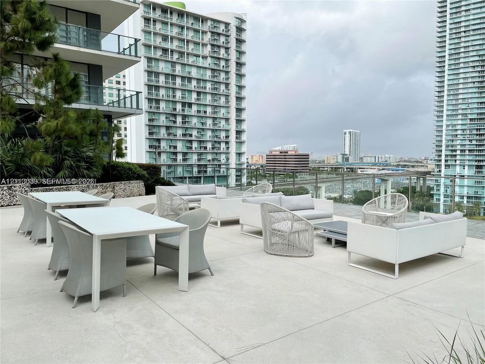 Expansive outdoor terrace featuring concrete flooring and a glass railing