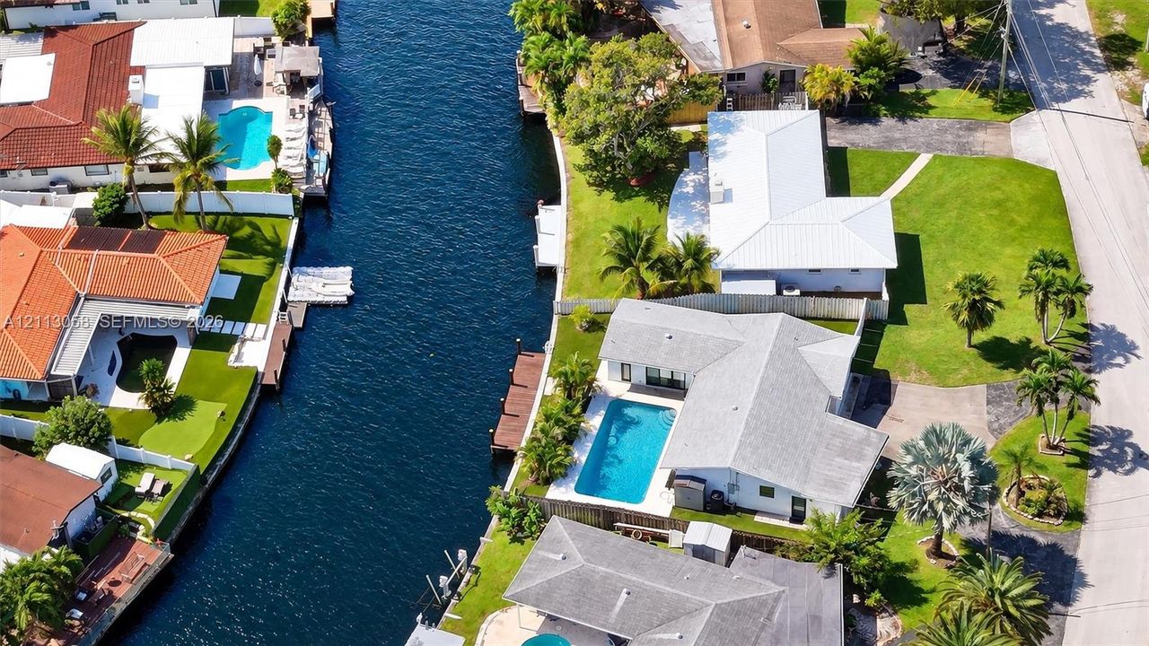 Waterfront property featuring a private boat dock, canal access, and an in-ground swimming pool