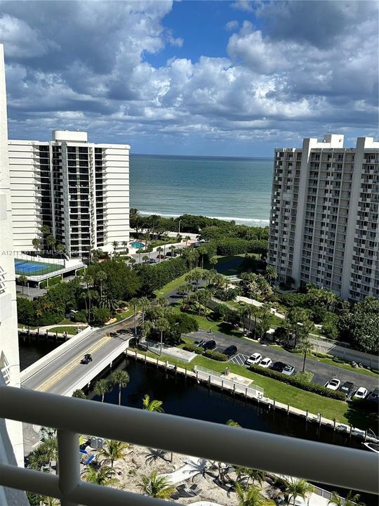 Elevated balcony featuring metal railings with ocean and coastal surroundings
