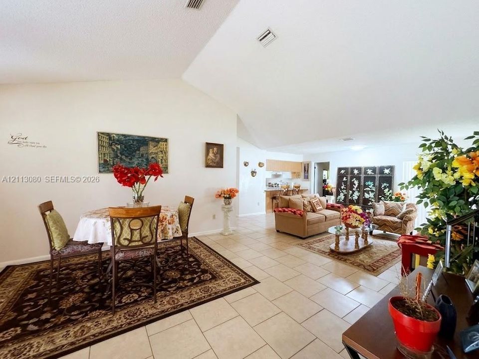 Open floor plan featuring vaulted ceilings and ceramic tile flooring throughout