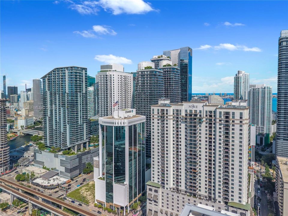High-rise urban landscape featuring a dense cluster of multi-story towers with glass and concrete facades and balcony configurations