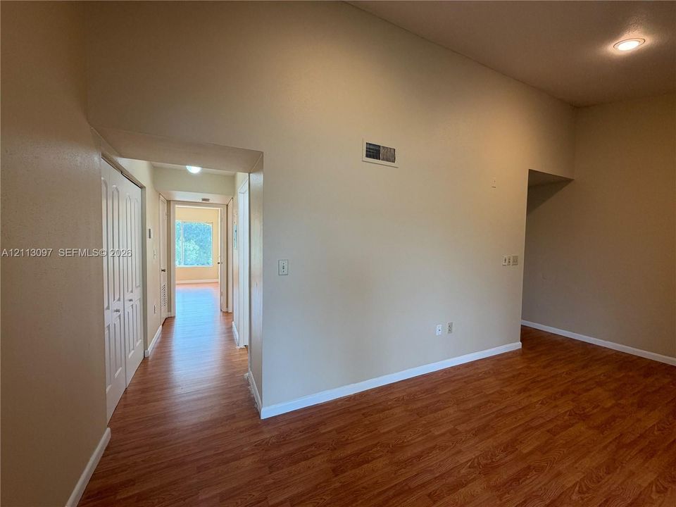 Vaulted ceilings, wood-finish flooring, and double-door closet cabinetry