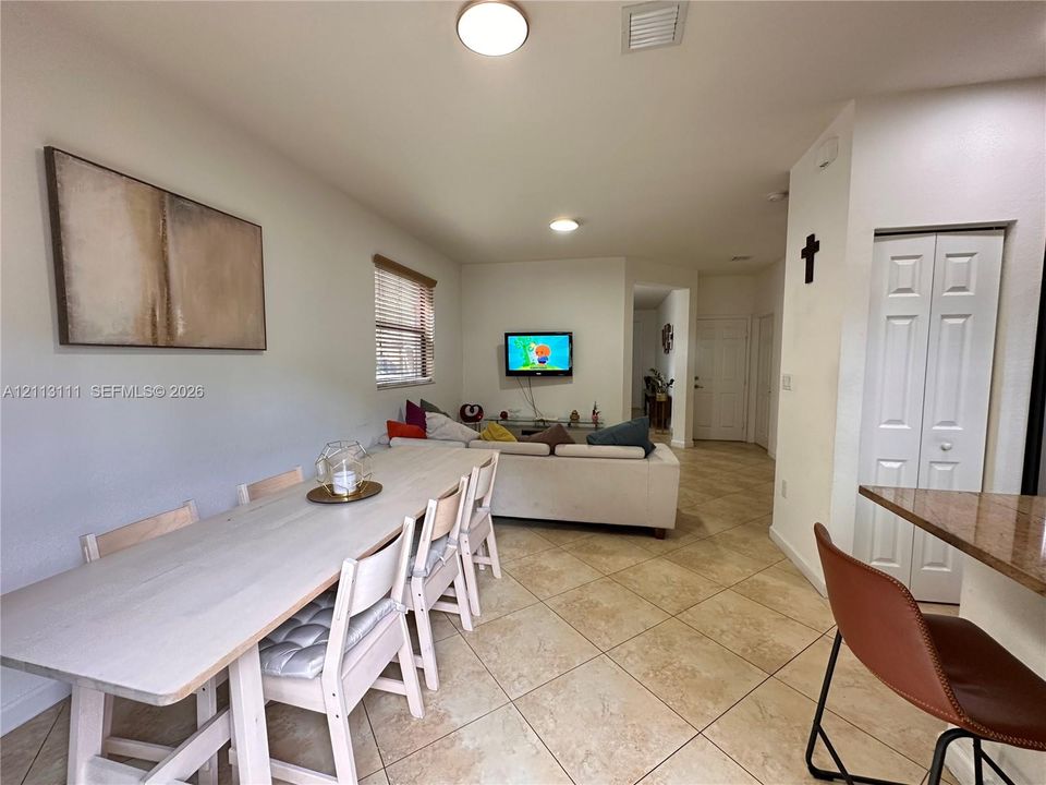 Large-format ceramic tile flooring throughout, neutral interior wall paint, flush-mount ceiling lighting, and bifold closet doors