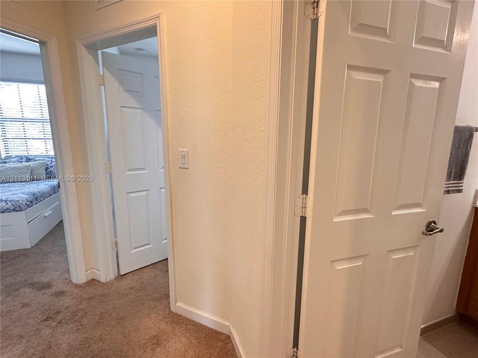Textured wall finishes, interior six-panel doors, and wall-to-wall carpeting