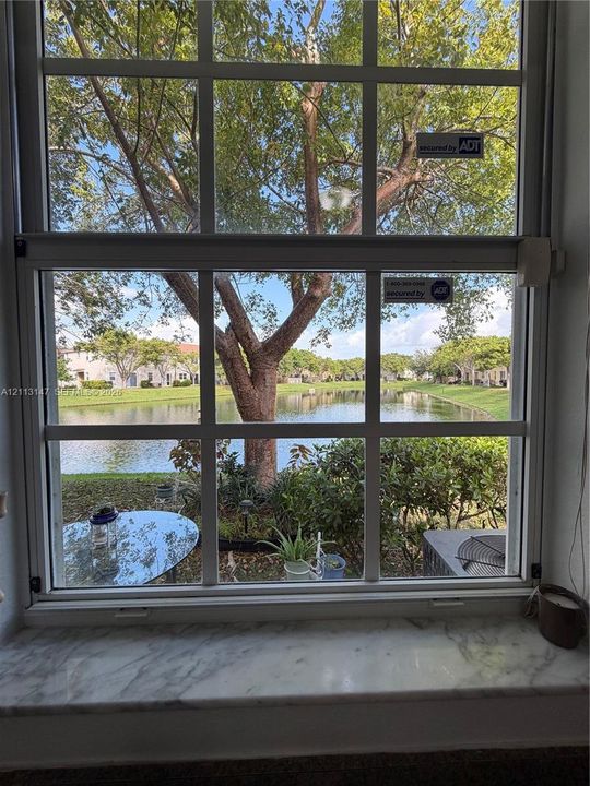 Multi-pane single-hung window featuring a natural stone sill and waterfront exposure
