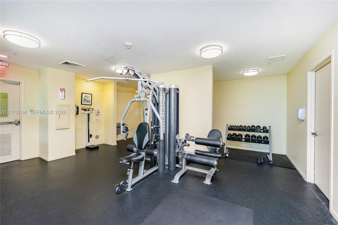 Fitness center featuring rubber flooring, recessed ceiling lighting, and multiple weight-training stations