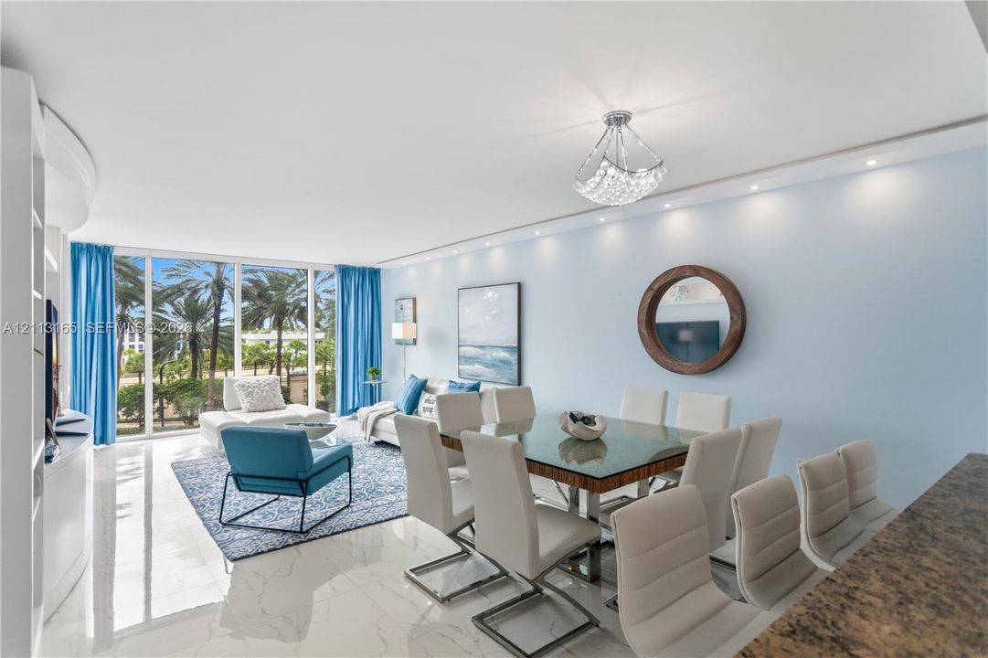 Floor-to-ceiling glass windows, polished tile flooring, recessed ceiling lighting, decorative crystal-style chandelier, and built-in cabinetry