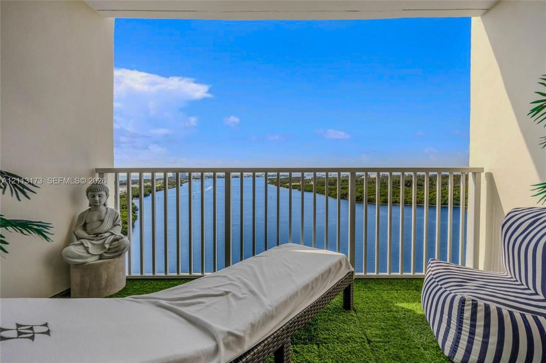 Private balcony featuring a metal railing and water scenery