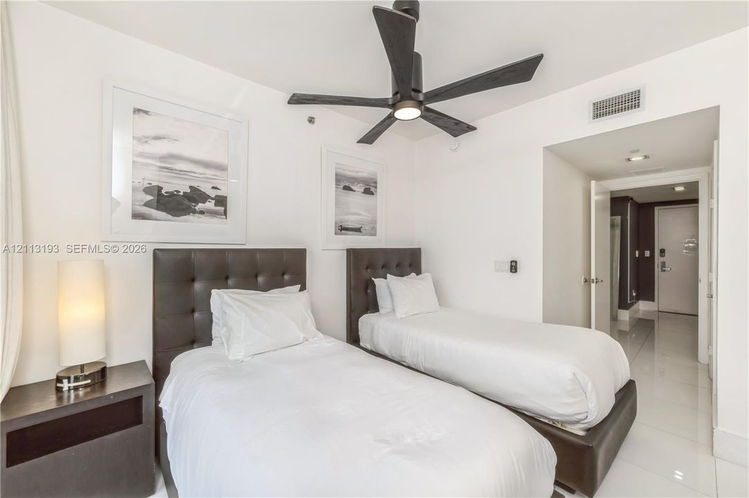 Polished tile flooring, matte black five-blade ceiling fan, and recessed lighting