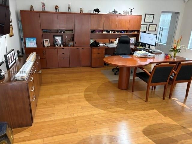 Built-in wall-to-wall wood cabinetry with extensive storage and integrated shelving, complemented by wood-finish flooring
