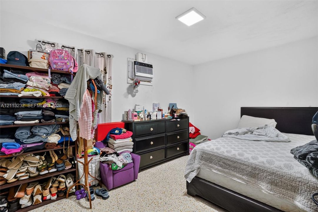 Interior space featuring smooth-finish ceilings, recessed square lighting, and speckled hard-surface flooring