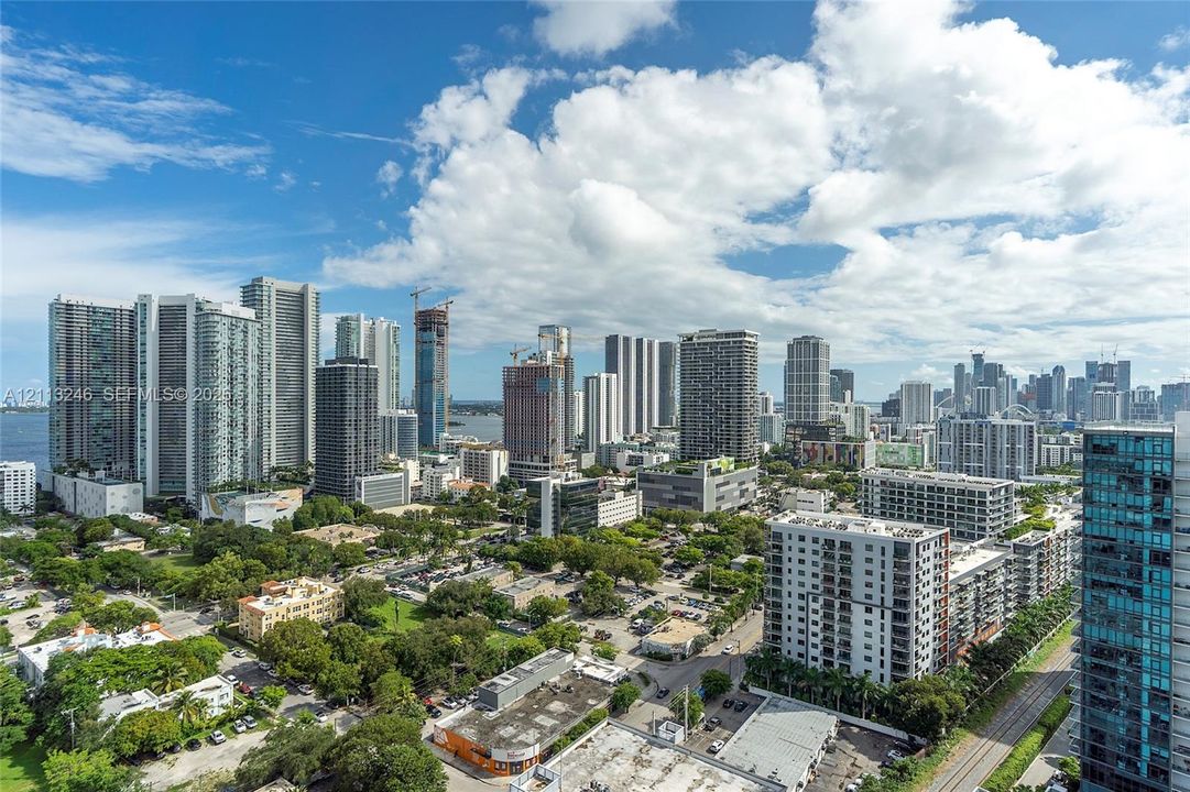 Elevated urban perspective featuring high-rise architecture, glass-clad building facades, and metropolitan skyline scenery