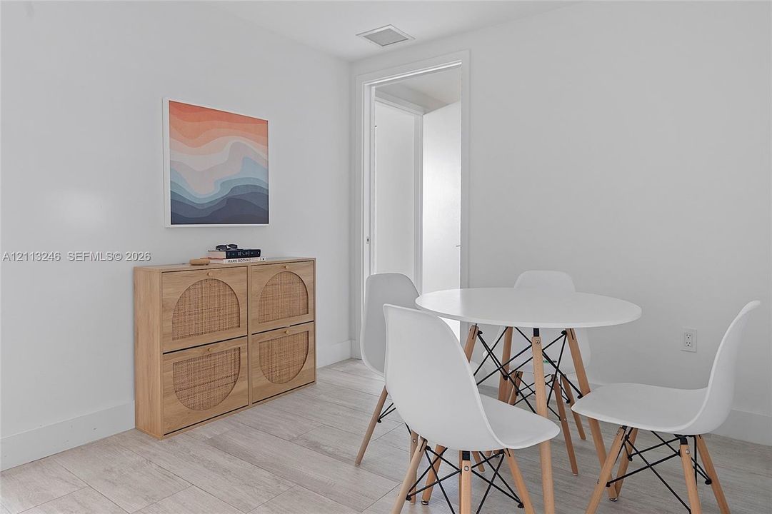 Neutral-toned wood-finish flooring and smooth, light-toned walls
