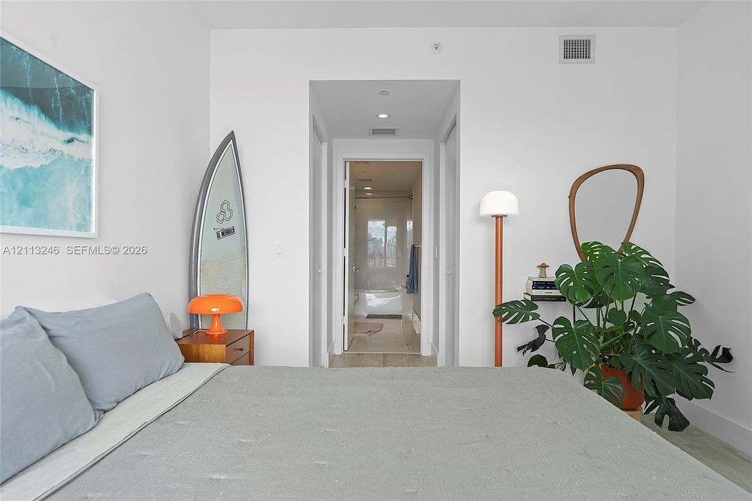 Neutral interior space featuring recessed ceiling lighting, crisp white wall finishes, and light-toned flooring