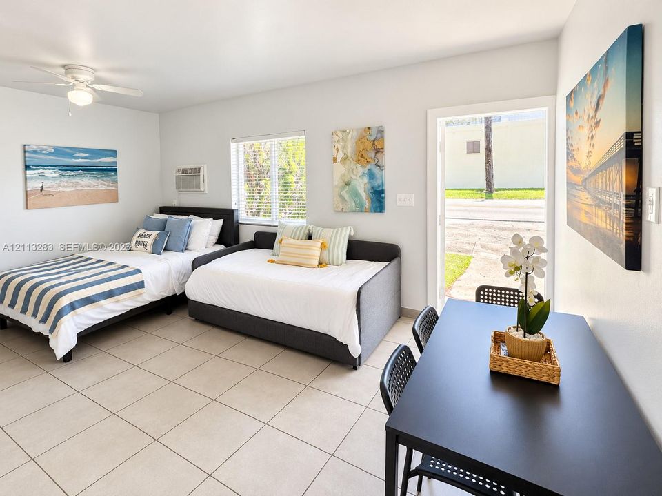 Neutral tile flooring, ceiling fan with integrated lighting, and direct exterior access