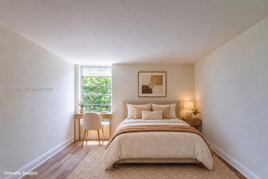 Room featuring neutral wall finishes and wood-finish flooring with a multi-pane window