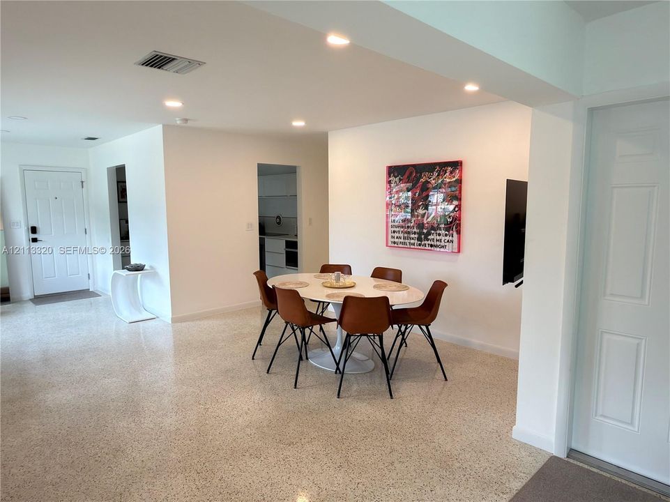 Open-concept interior featuring light-toned terrazzo flooring and recessed ceiling lighting