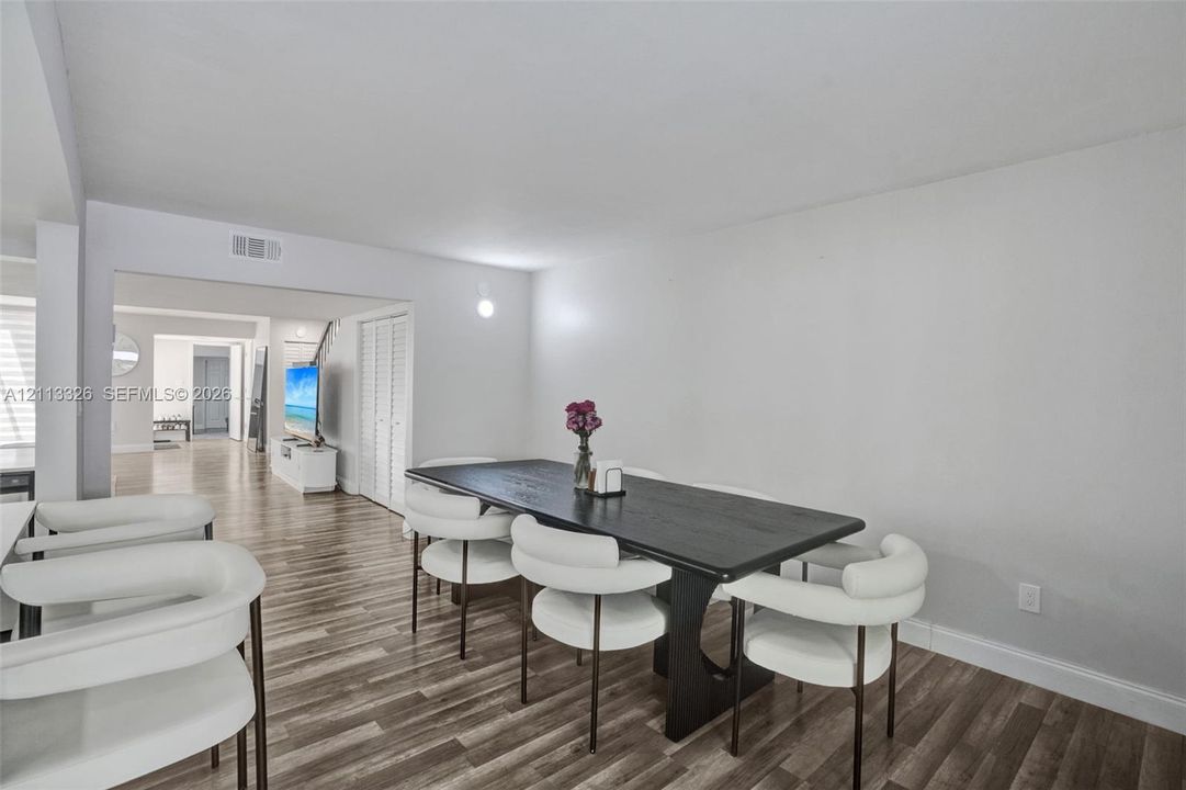 Wood-finish flooring, neutral wall tones, and bifold closet doors