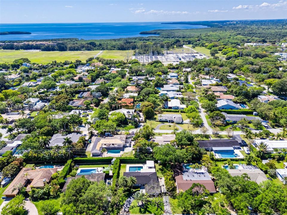 Aerial perspective featuring dense canopy coverage and proximity to the coastline