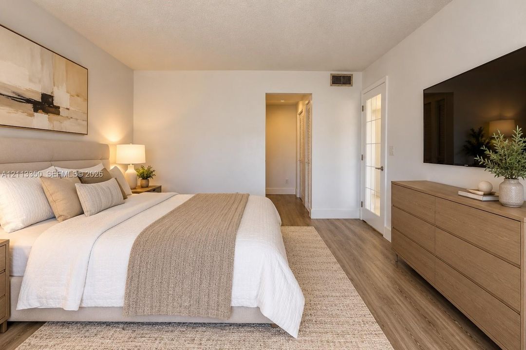 AI RENDERING-Bedroom featuring wood-finish flooring, a multi-pane glass door, and neutral wall tones