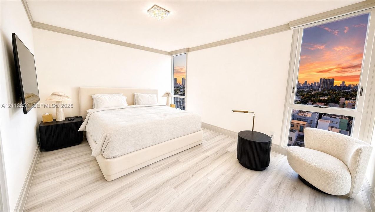 Floor-to-ceiling windows with skyline backdrop, wood-finish flooring, and recessed ceiling lighting