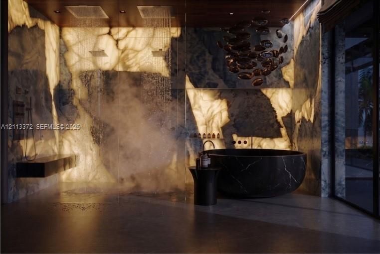Backlit stone wall cladding featuring dual rainfall showerheads, a freestanding circular soaking tub, glass shower enclosure, and a built-in wall-mounted bench