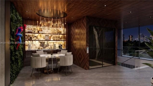Wood-paneled ceilings, integrated backlighting, vertical interior garden wall, floor-to-ceiling glass enclosure, and stone-finish flooring