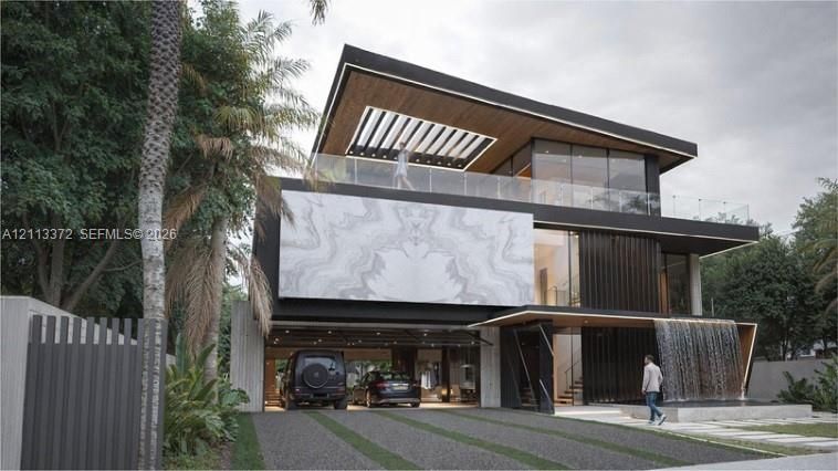 Contemporary multi-level exterior featuring a stone-clad facade, a covered ground-level parking area, a glass-railed upper terrace with a wood-paneled ceiling, and a built-in water feature