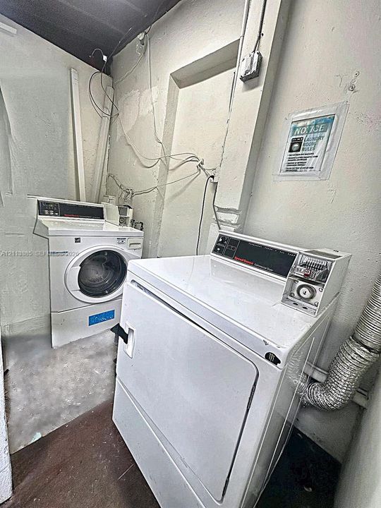 Laundry space equipped with a coin-operated dryer and a front-load washing machine