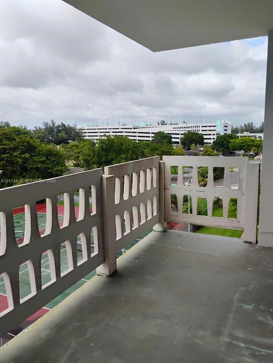 Private balcony with a decorative concrete screen and smooth flooring